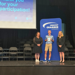A finalist is recognized on stage at the 2026 National Civics Bee Vermont State Finals