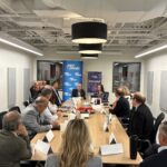 Attendees seated around a table during the Vermont Chamber's Wellspring Forum.