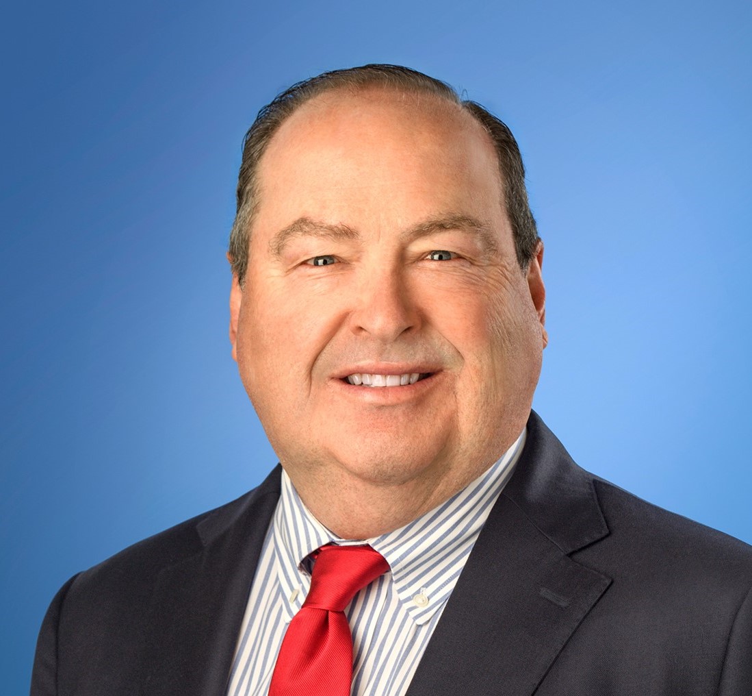 Ken Entenmann headshot on blue background