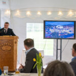 MG Knight standing at a podium speaking to a crowd