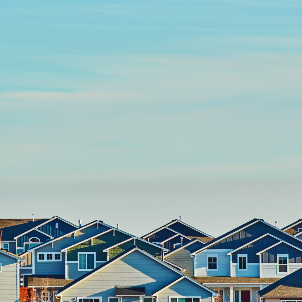 A picture of houses with a blue sky backdrop