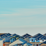 A picture of houses with a blue sky backdrop