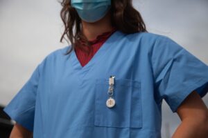 A picture of a healthcare worker in scrubs wearing a mask